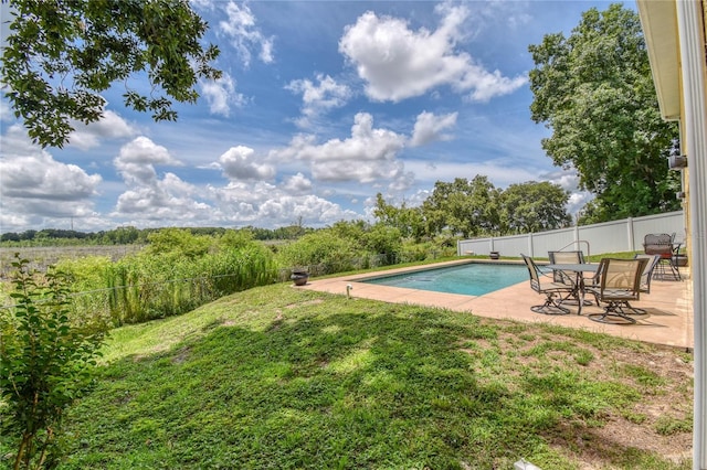 view of pool featuring a patio and a yard