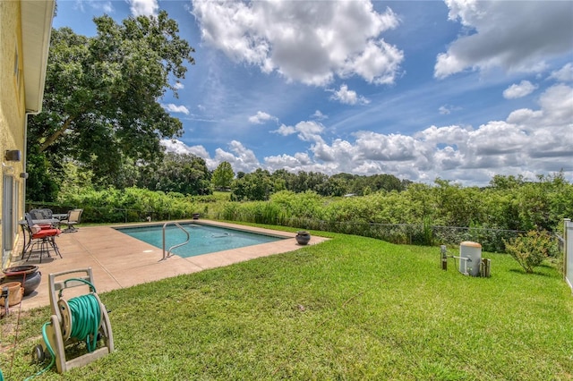 view of pool with a yard and a patio area