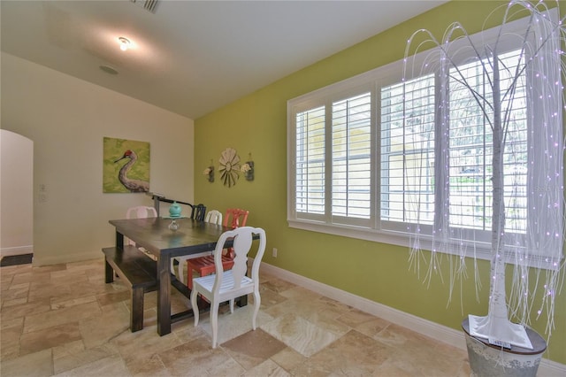 dining space featuring lofted ceiling