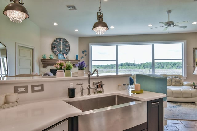 kitchen featuring plenty of natural light, sink, ceiling fan with notable chandelier, and decorative light fixtures