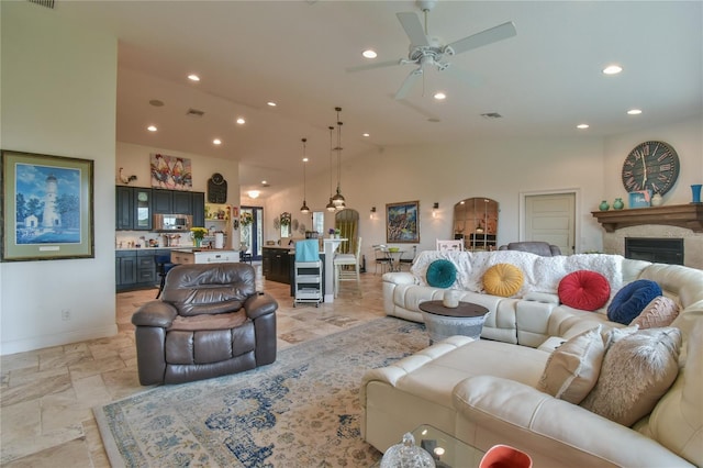 living room with ceiling fan and vaulted ceiling