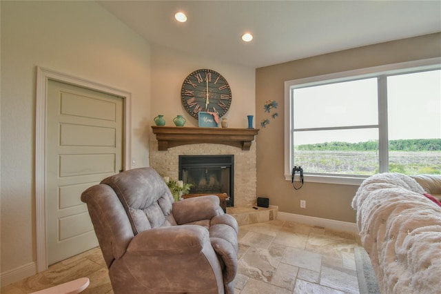 living room with a stone fireplace