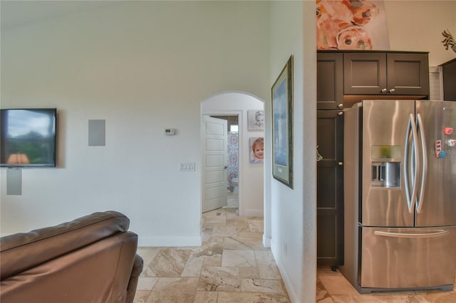 kitchen featuring stainless steel fridge with ice dispenser and dark brown cabinets