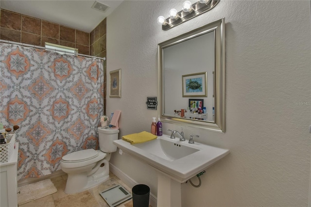 bathroom with walk in shower, sink, and toilet