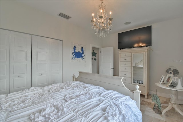 bedroom with an inviting chandelier and a closet