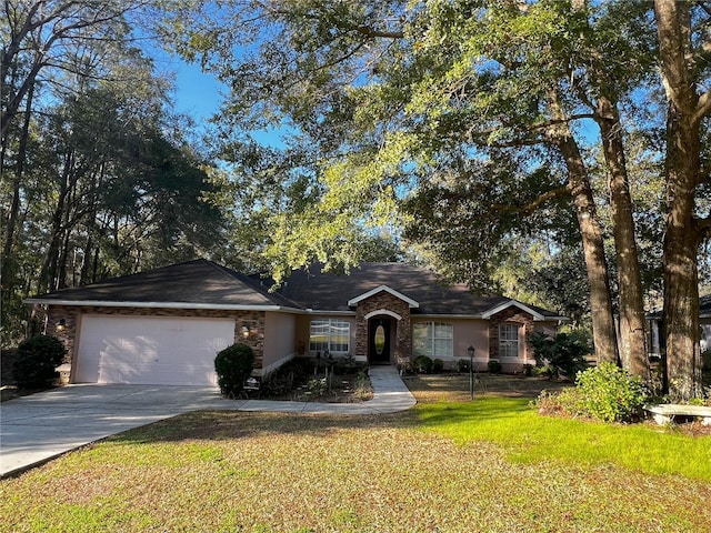 single story home featuring a garage and a front yard