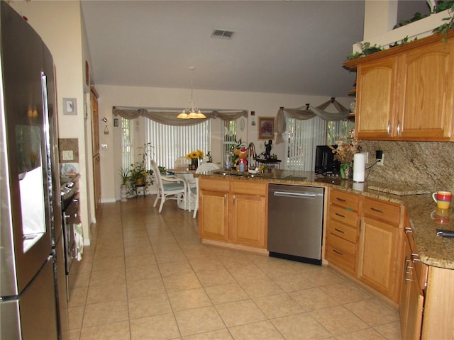 kitchen with tasteful backsplash, hanging light fixtures, light tile patterned floors, stainless steel appliances, and light stone countertops