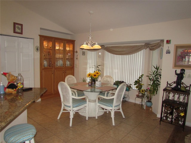 tiled dining space with vaulted ceiling