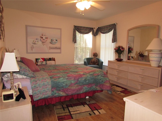 bedroom with dark hardwood / wood-style floors and ceiling fan