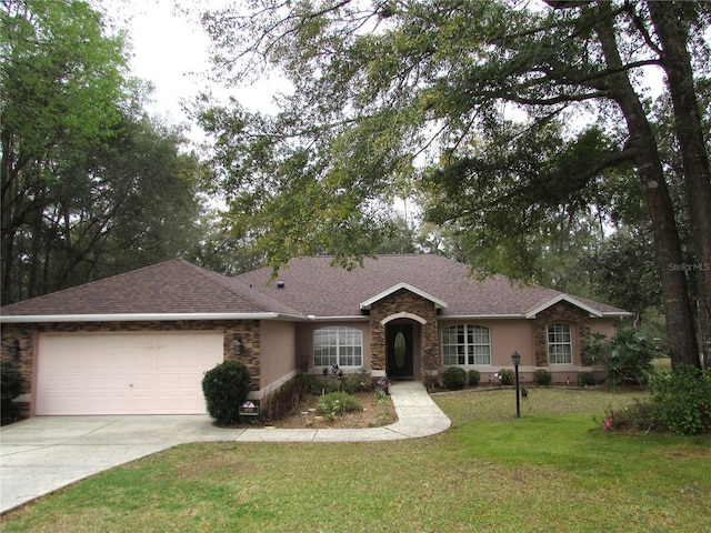 single story home featuring a front lawn and a garage