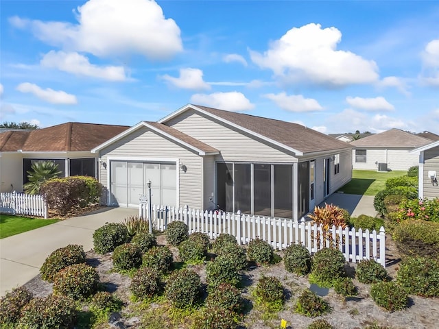 ranch-style home featuring a garage and a sunroom