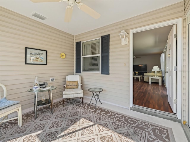 exterior space with ceiling fan and a porch