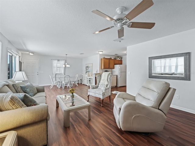 living room featuring plenty of natural light, dark hardwood / wood-style floors, and ceiling fan