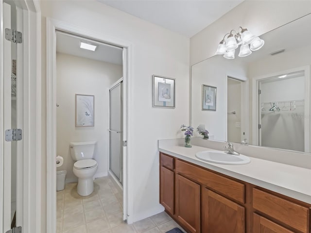 bathroom with vanity, toilet, and an enclosed shower