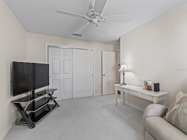 interior space featuring light colored carpet and ceiling fan