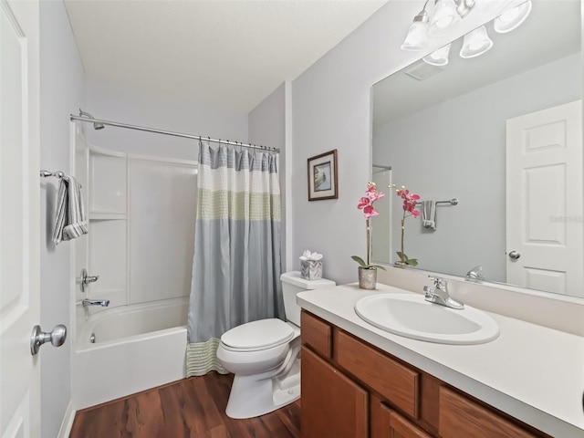 full bathroom with shower / tub combo with curtain, hardwood / wood-style floors, vanity, and toilet