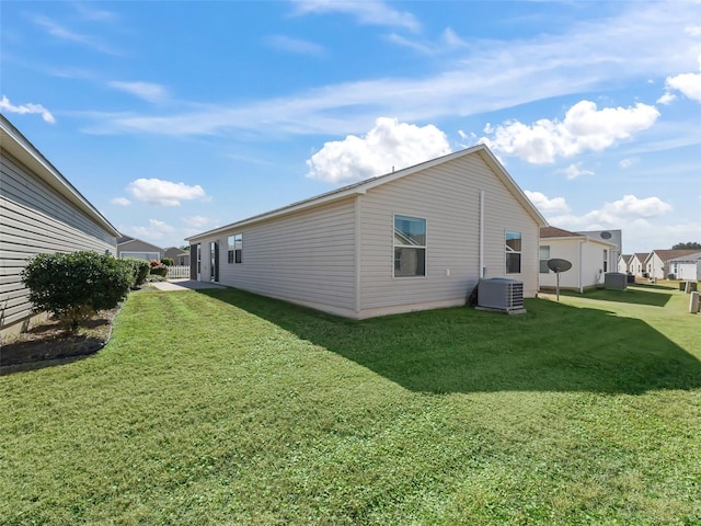 view of home's exterior featuring central AC and a lawn