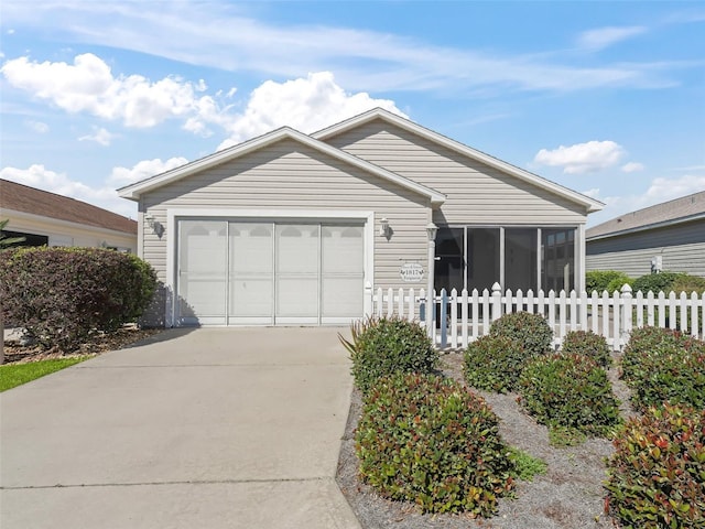 single story home with a garage and a sunroom