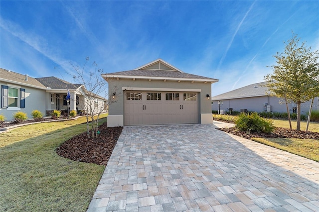 view of front of house featuring a garage and a front lawn