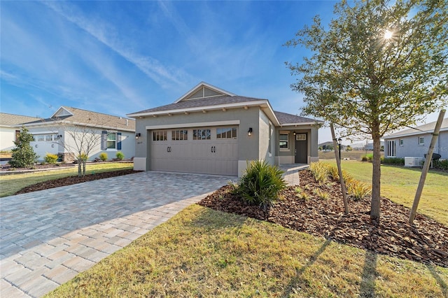 view of front facade with a garage and a front lawn