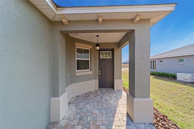 property entrance with a lawn