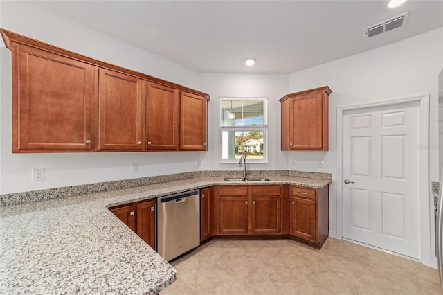 kitchen featuring stainless steel dishwasher, light stone countertops, and sink