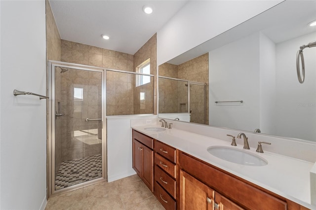 bathroom with vanity and a shower with shower door