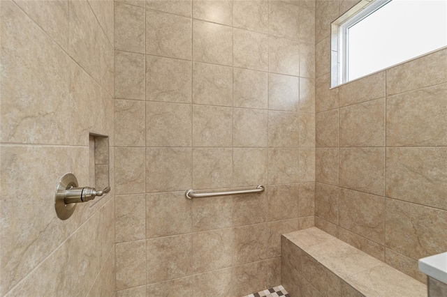 bathroom with a tile shower