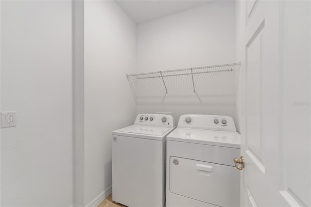 clothes washing area featuring washing machine and clothes dryer