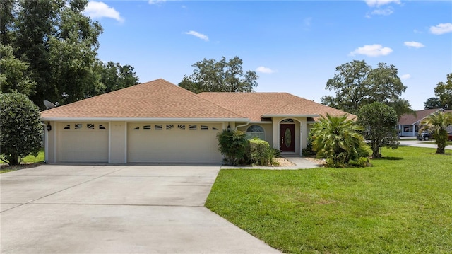 view of front of house featuring a garage and a front lawn