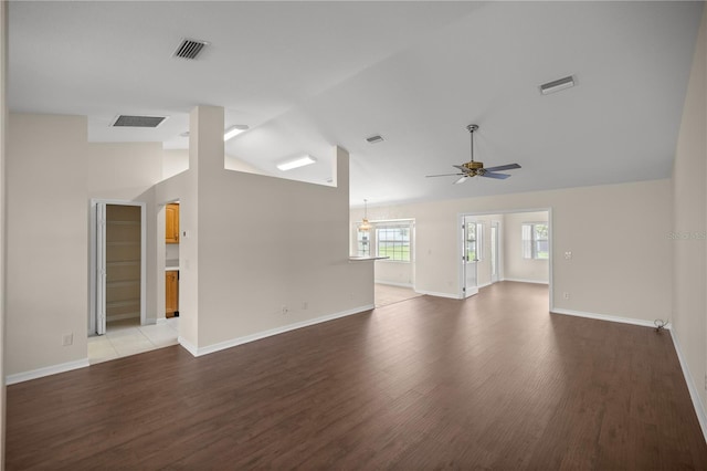 unfurnished living room featuring lofted ceiling, wood-type flooring, and ceiling fan