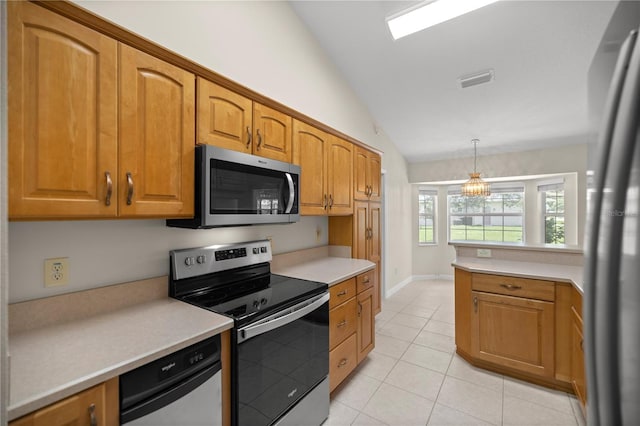 kitchen featuring light tile patterned floors, vaulted ceiling, stainless steel appliances, and hanging light fixtures