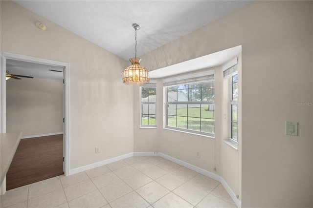 unfurnished room featuring ceiling fan with notable chandelier and light tile patterned floors