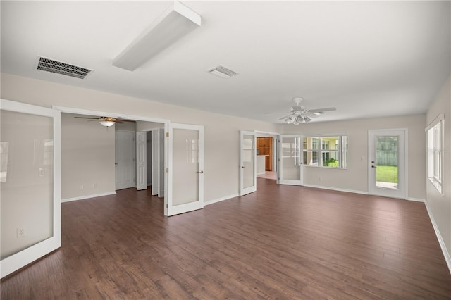 unfurnished living room with dark hardwood / wood-style flooring, ceiling fan, and french doors