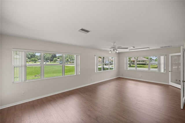 spare room featuring ceiling fan and dark hardwood / wood-style flooring