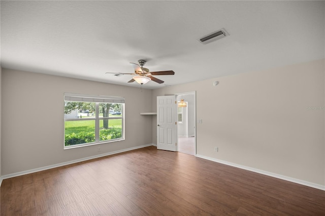 unfurnished room featuring ceiling fan and dark hardwood / wood-style floors