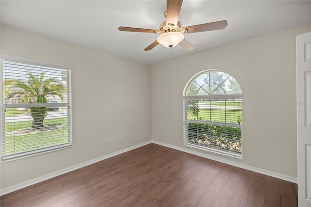 unfurnished room with dark hardwood / wood-style floors and ceiling fan