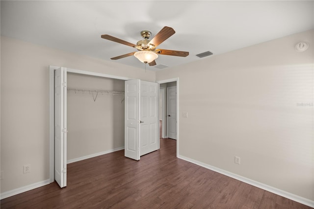 unfurnished bedroom featuring dark hardwood / wood-style floors, a closet, and ceiling fan