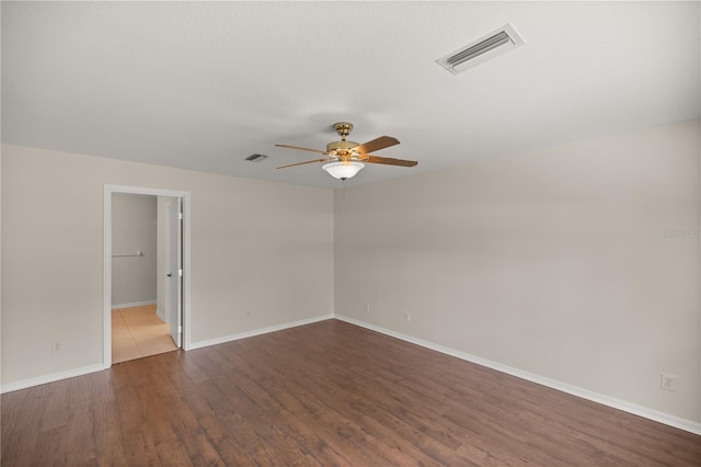 unfurnished room featuring ceiling fan and dark hardwood / wood-style flooring