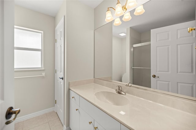 bathroom with tile patterned flooring, vanity, a chandelier, and walk in shower