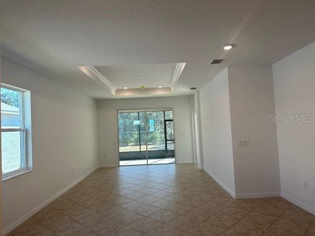 spare room featuring a tray ceiling