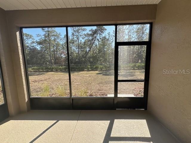 unfurnished sunroom with wooden ceiling