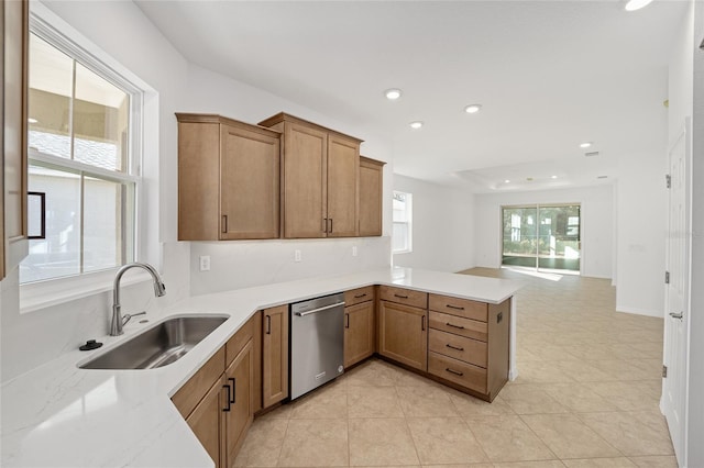 kitchen featuring light tile patterned flooring, sink, stainless steel dishwasher, and kitchen peninsula