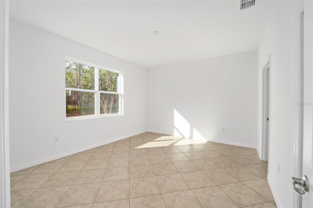 empty room with light tile patterned floors