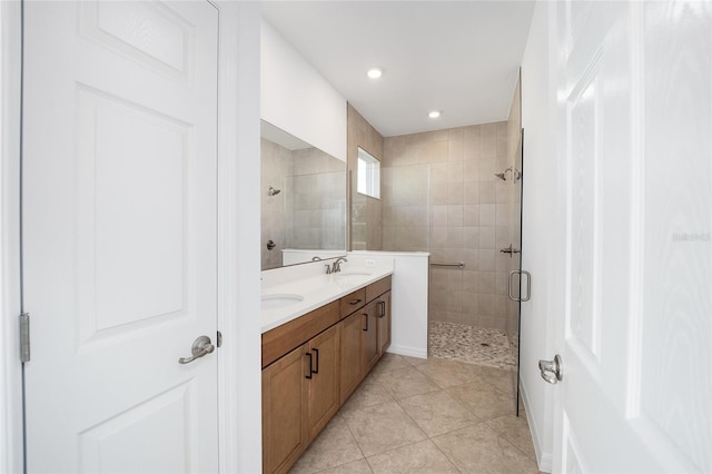 bathroom featuring an enclosed shower, vanity, and tile patterned flooring