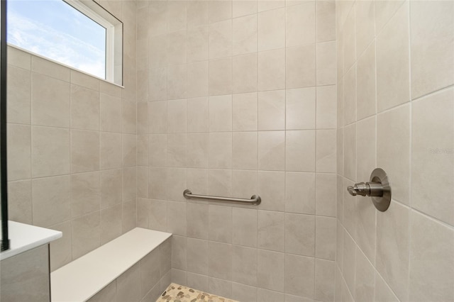 bathroom with a tile shower