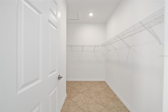 walk in closet with light tile patterned floors