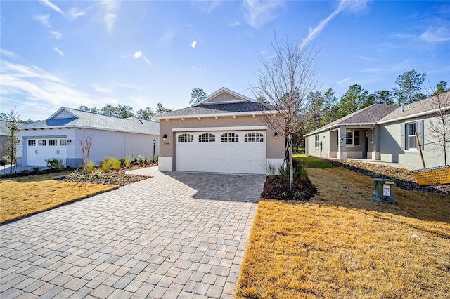 view of front of home featuring a garage and a front lawn