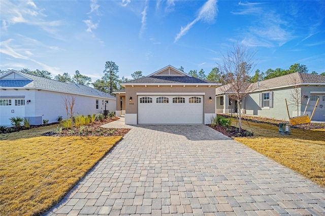 view of front facade with a garage and a front lawn