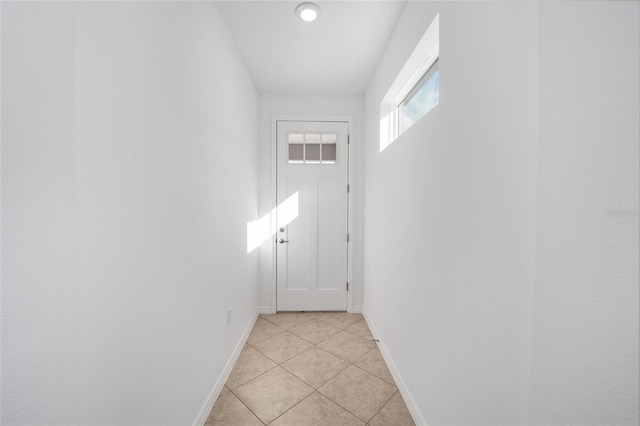 doorway with light tile patterned floors